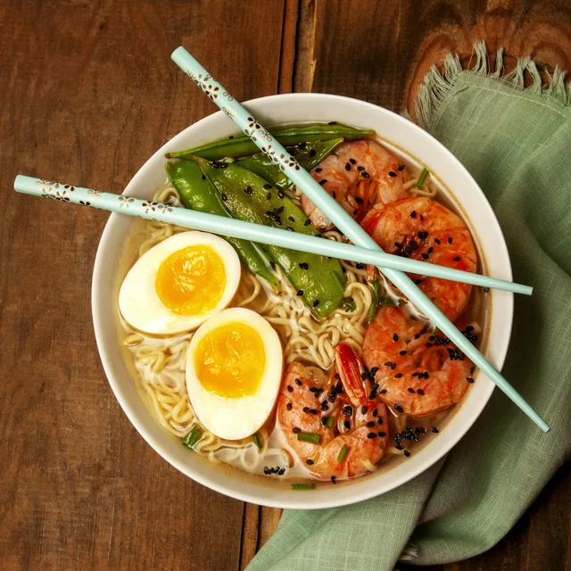 A bowl of ramen with egg, shrimp and snow peas; contextual food photography, not a verified restaurant dish.